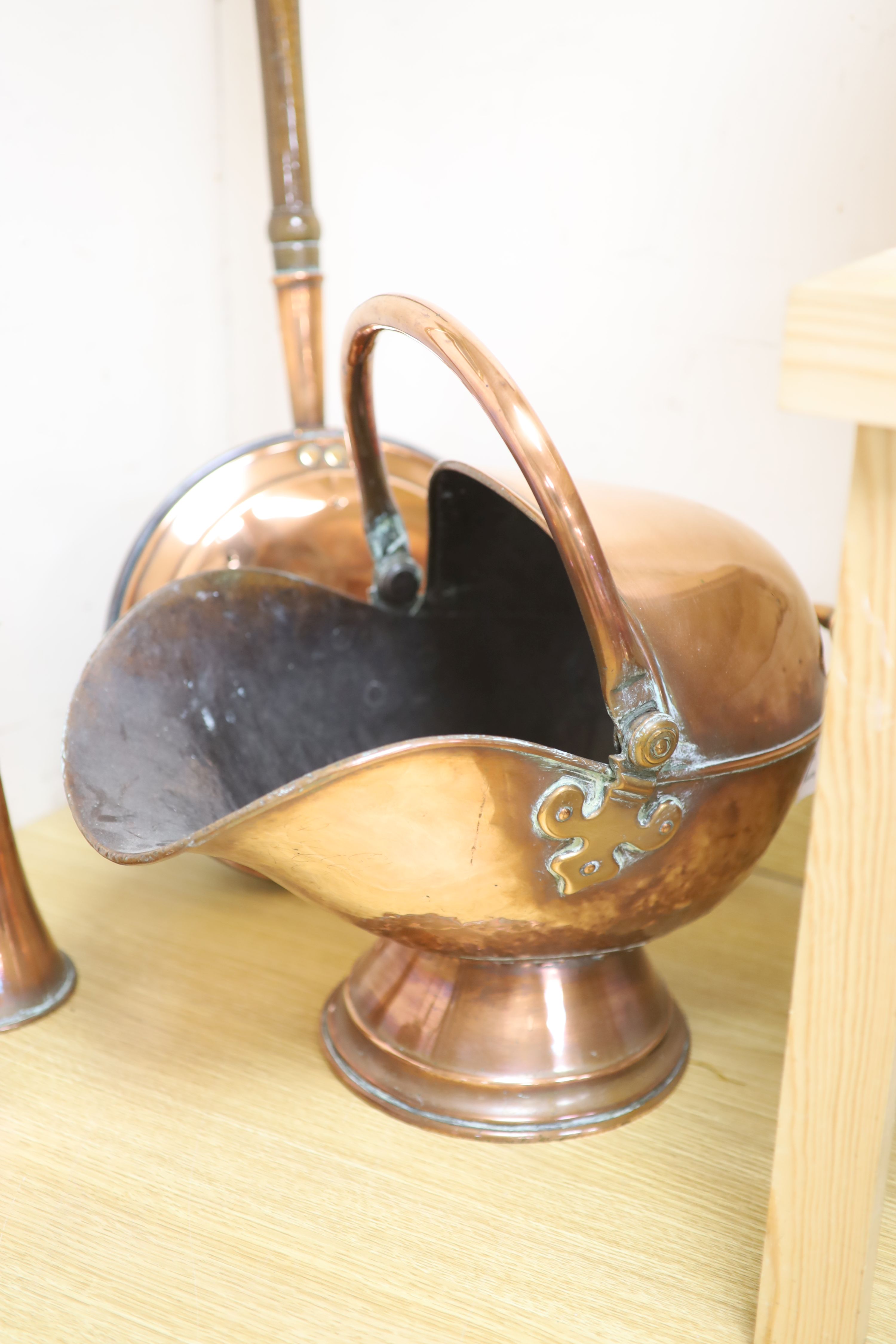 A Victorian copper coal helmet, A Victorian copper kettle, a Victorian copper coaching horn and sundry metalware